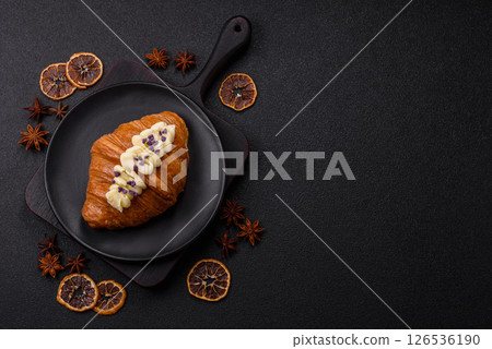 Sweet crispy fresh croissant with berry filling Sweet crispy fresh croissant with berry filling 126536190