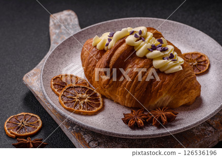 Sweet crispy fresh croissant with berry filling Sweet crispy fresh croissant with berry filling 126536196