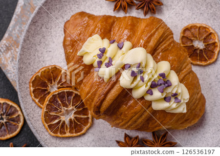 Sweet crispy fresh croissant with berry filling Sweet crispy fresh croissant with berry filling 126536197