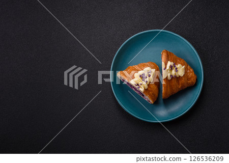 Sweet crispy fresh croissant with berry filling Sweet crispy fresh croissant with berry filling 126536209