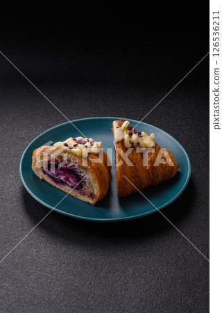 Sweet crispy fresh croissant with berry filling 126536211