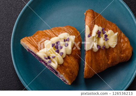 Sweet crispy fresh croissant with berry filling Sweet crispy fresh croissant with berry filling 126536213