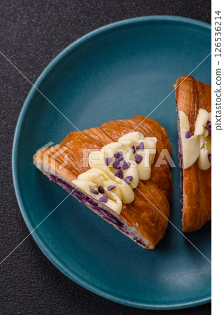Sweet crispy fresh croissant with berry filling Sweet crispy fresh croissant with berry filling 126536214