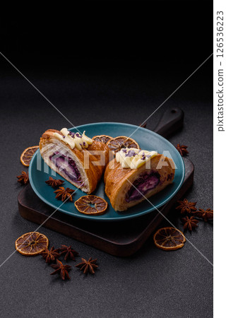 Sweet crispy fresh croissant with berry filling 126536223