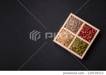 A box of peanuts and cedar nuts and sunflower and pumpkin seeds 126536313