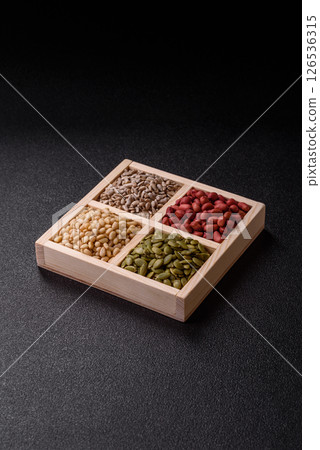 A box of peanuts and cedar nuts and sunflower and pumpkin seeds A box of peanuts and cedar nuts and sunflower and pumpkin seeds 126536315