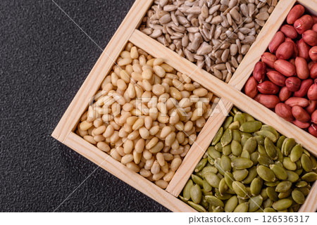 A box of peanuts and cedar nuts and sunflower and pumpkin seeds 126536317