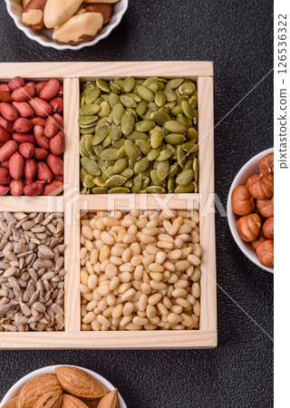 A box of peanuts and cedar nuts and sunflower and pumpkin seeds 126536322