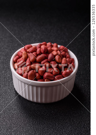 Peanuts or peeled graundnut in a bowl on a dark concrete background 126536335