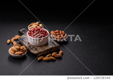 Peanuts or peeled graundnut in a bowl on a dark concrete background 126536340