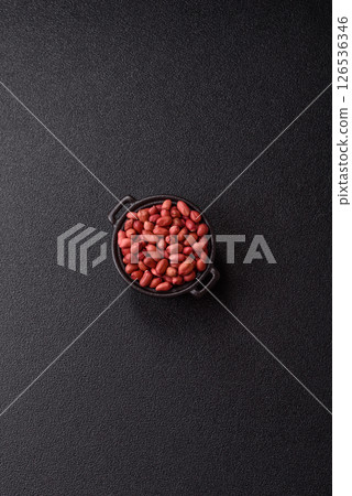 Peanuts or peeled graundnut in a bowl on a dark concrete background Peanuts or peeled graundnut in a bowl on a dark concrete background 126536346