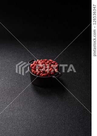 Peanuts or peeled graundnut in a bowl on a dark concrete background Peanuts or peeled graundnut in a bowl on a dark concrete background 126536347