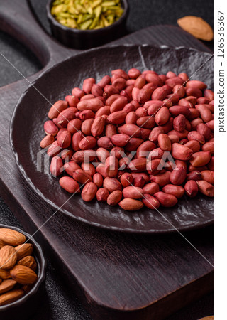 Peanuts or peeled graundnut in a bowl on a dark concrete background 126536367