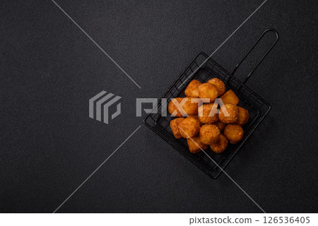 Cheese or potato croquettes, balls fried in breading with salt, spices Cheese or potato croquettes, balls fried in breading with salt, spices 126536405