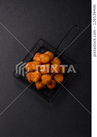 Cheese or potato croquettes, balls fried in breading with salt, spices 126536406