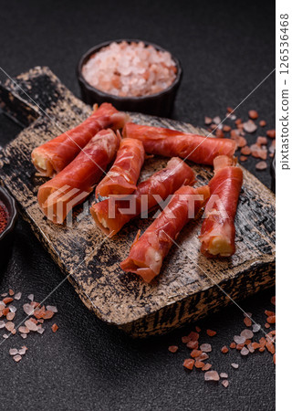 Cheese and meat, jamon or prosciutto rolled into a roll Cheese and meat, jamon or prosciutto rolled into a roll 126536468