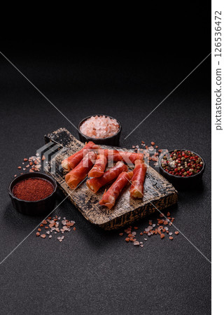 Cheese and meat, jamon or prosciutto rolled into a roll 126536472