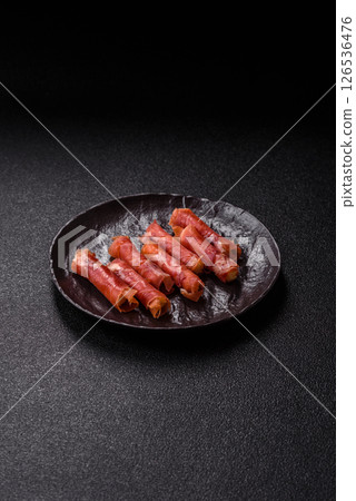 Cheese and meat, jamon or prosciutto rolled into a roll Cheese and meat, jamon or prosciutto rolled into a roll 126536476