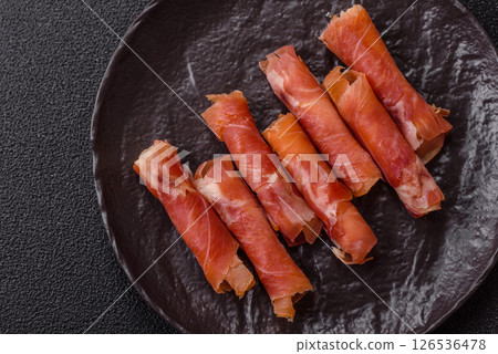 Cheese and meat, jamon or prosciutto rolled into a roll 126536478