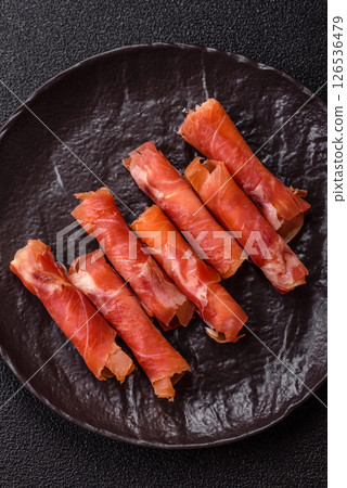 Cheese and meat, jamon or prosciutto rolled into a roll 126536479