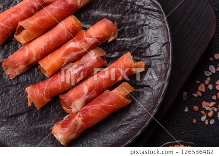 Cheese and meat, jamon or prosciutto rolled into a roll 126536482