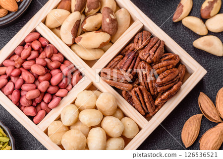 Wooden box with macadamia nuts, Brazil nuts, pecans and peanuts 126536521
