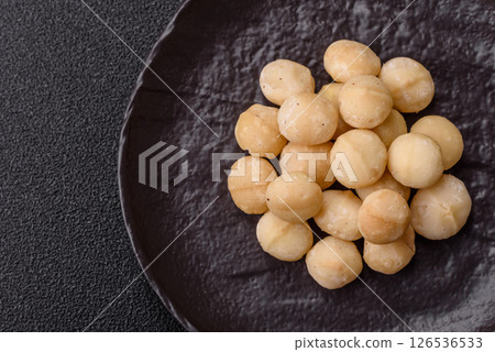 Raw peeled macadamia nut in ceramic bowl 126536533