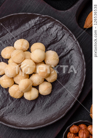 Raw peeled macadamia nut in ceramic bowl 126536538