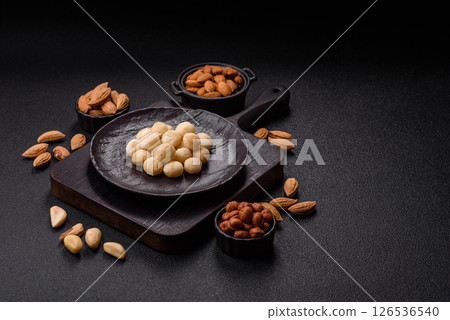 Raw peeled macadamia nut in ceramic bowl 126536540