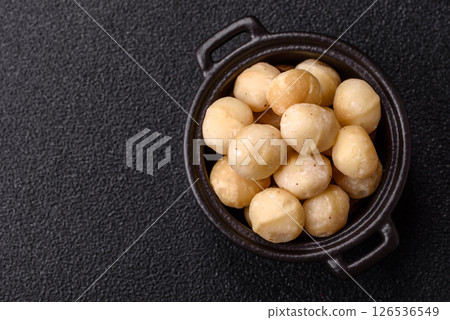 Raw peeled macadamia nut in ceramic bowl Raw peeled macadamia nut in ceramic bowl 126536549