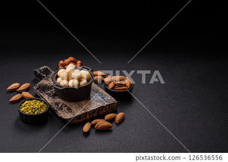 Raw peeled macadamia nut in ceramic bowl 126536556
