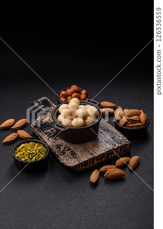 Raw peeled macadamia nut in ceramic bowl 126536559