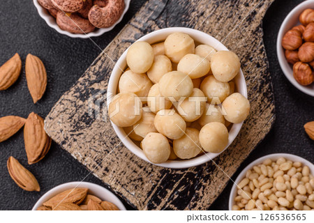 Raw peeled macadamia nut in ceramic bowl 126536565