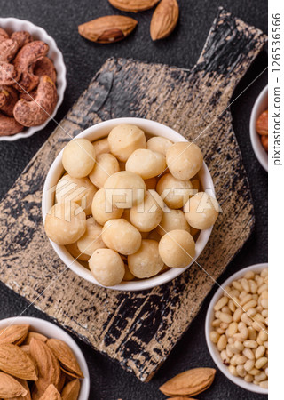 Raw peeled macadamia nut in ceramic bowl 126536566