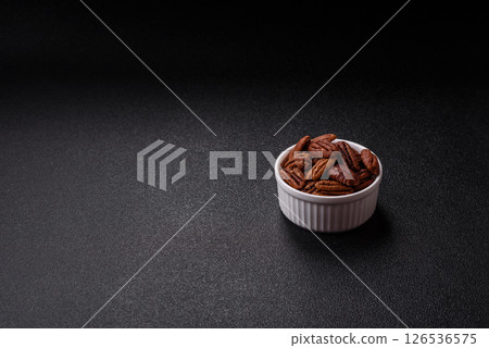Nut, pecans in a ceramic bowl, an ingredient in vegan food 126536575
