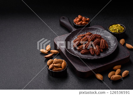 Nut, pecans in a ceramic bowl, an ingredient in vegan food 126536591
