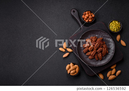 Nut, pecans in a ceramic bowl, an ingredient in vegan food 126536592