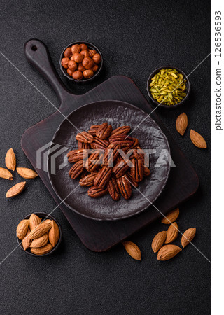 Nut, pecans in a ceramic bowl, an ingredient in vegan food Nut, pecans in a ceramic bowl, an ingredient in vegan food 126536593