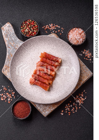 Cheese and meat, jamon or prosciutto rolled into a roll 126536598