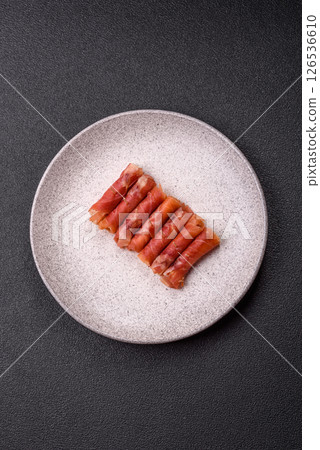 Cheese and meat, jamon or prosciutto rolled into a roll 126536610