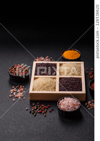 White and red raw rice grains in a ceramic bowl. Rice as an ingredient 126536620