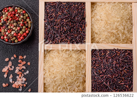 White and red raw rice grains in a ceramic bowl. Rice as an ingredient 126536622