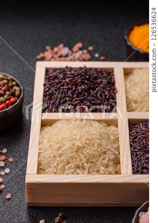 White and red raw rice grains in a ceramic bowl. Rice as an ingredient 126536624