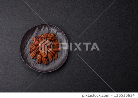Nut, pecans in a ceramic bowl, an ingredient in vegan food 126536634