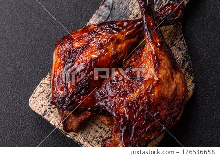 Duck, chicken leg or thigh grilled on a dark concrete background Duck, chicken leg or thigh grilled on a dark concrete background 126536658