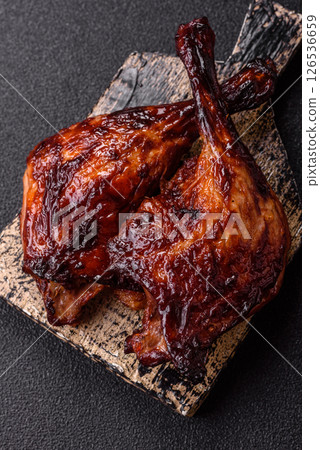 Duck, chicken leg or thigh grilled on a dark concrete background Duck, chicken leg or thigh grilled on a dark concrete background 126536659