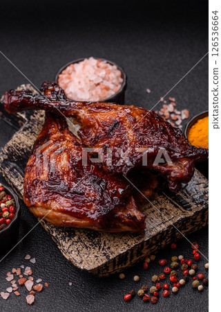 Duck, chicken leg or thigh grilled on a dark concrete background Duck, chicken leg or thigh grilled on a dark concrete background 126536664