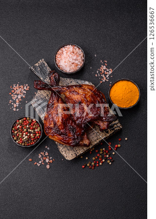 Duck, chicken leg or thigh grilled on a dark concrete background 126536667