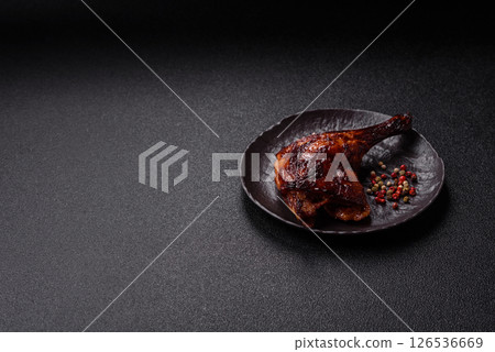 Duck, chicken leg or thigh grilled on a dark concrete background 126536669