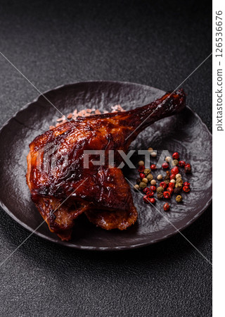Duck, chicken leg or thigh grilled on a dark concrete background 126536676